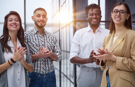Laughing multiethnic business people talking in the office.