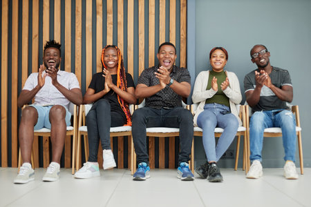 Group of happy employees applauds in the conference room