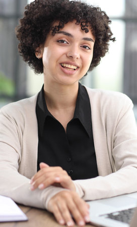Portrait of Young Successful Caucasian Businesswoman Sitting at Desk Working on Laptop