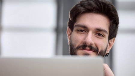 Businessman using a laptop while working late in his office