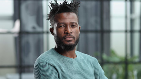 Thoughtful young black man looking straight aheadの写真素材