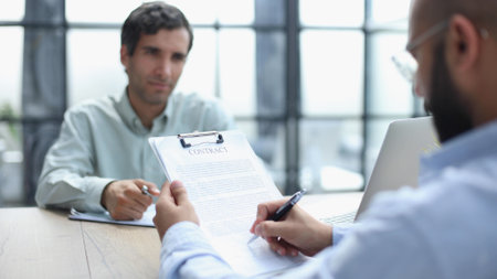 Businessman working on the table with laptop in a new officeの写真素材