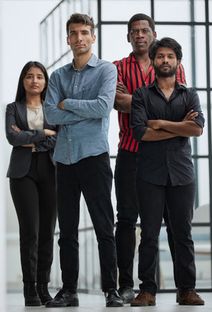 Friends smiling and standing together in officeの写真素材