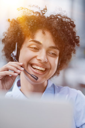 girl in a modern office working in a call center smilingの写真素材