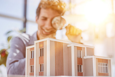 house searching, colorful mini model homes being viewed through magnifying glass, 3d render illustrationの写真素材
