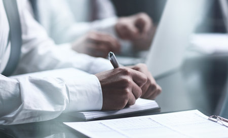 Close-up Of Businessman Filling Customer Survey Formの写真素材