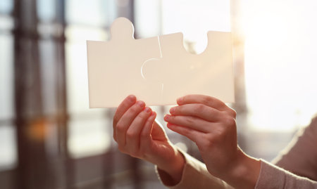 Business Woman holding two blank white puzzle pieces in her hands conceptual of solving a problem, growth and development.の写真素材