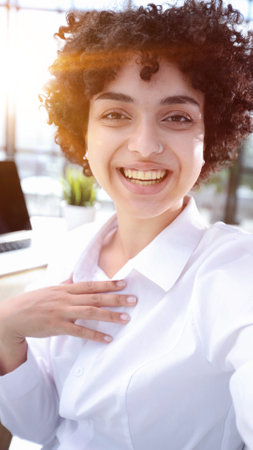 Portrait of Young Successful Businesswoman Sitting at Desk Working on Laptopの写真素材