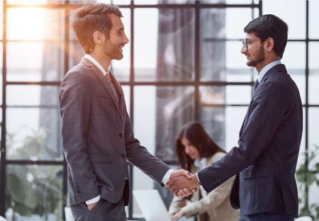 Let me take a look. Full length shot of two corporate businessmen meeting in the boardroom.の写真素材