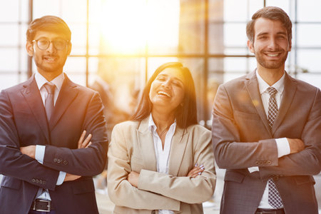 business people standing and looking straight ahead in a modern officeの写真素材