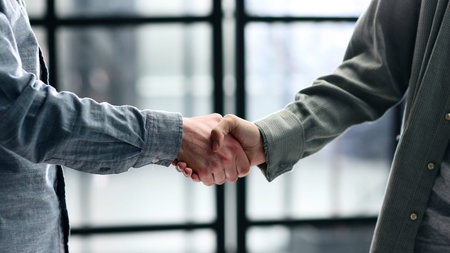 A close-up handshake in the office and a successful dealの写真素材