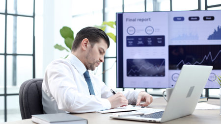 A successful office worker checks schedules and reportsの写真素材