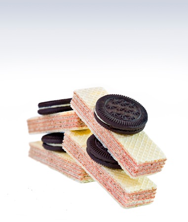 Chocolate and vanilla cream filled wafer biscuits on isolated white backgroundの写真素材