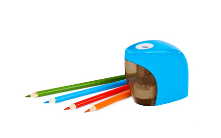 Electronic sharpner and orange, blue, red and gree pencil on isolated white backgroundの写真素材