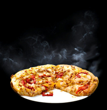 Chicken, onion and red capsicum pizza with smokeの写真素材