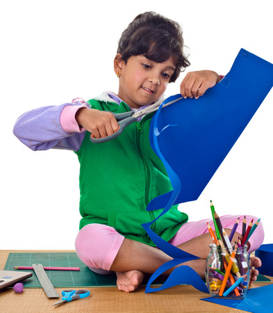 Child is making a school project using ruler and pencil on isolated white backgroundの写真素材