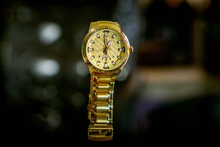 golden watch for man with beautiful texture. blur background with warmの写真素材