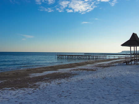 Pier on the beach in the winter snowの写真素材