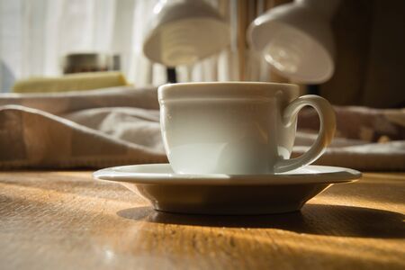 espresso cup on a wooden table in the sunlightの写真素材