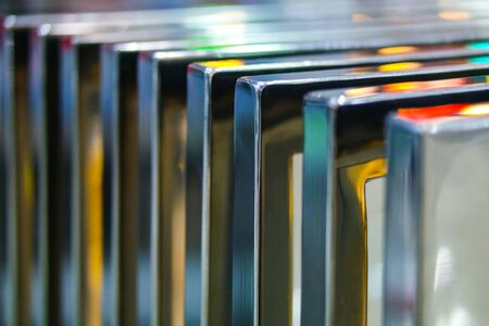 many chrome metal parts in colored lightの写真素材