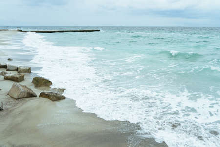 The coastline with concrete slabs on the shoreの写真素材
