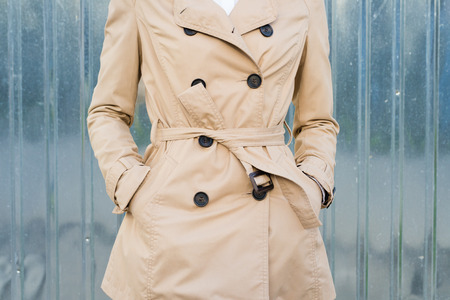 Woman in beige coat outdoors closeupの写真素材
