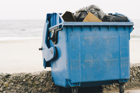 Blue garbage container on the coast