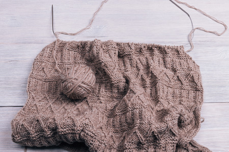 Knitted fabric with spokes lying on a wooden table