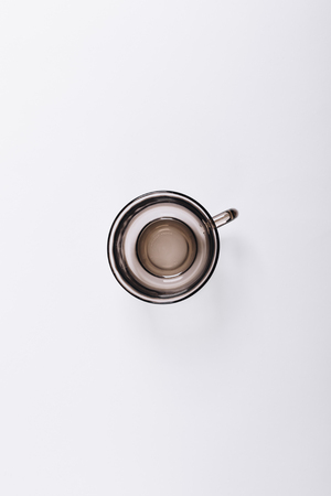 Minimalistic image of the empty cup on white background, top view, vertical frameの写真素材