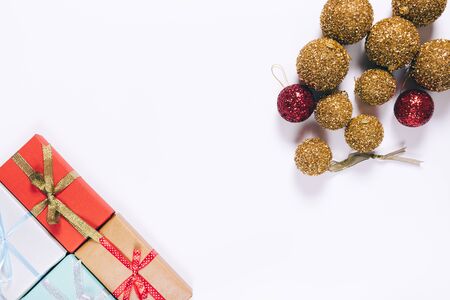 Gift boxes with bows and Christmas balls on a white background top viewの写真素材