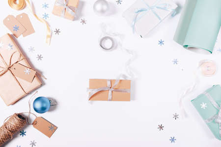 Top view of gifts and decorations for Christmas on a white tableの写真素材