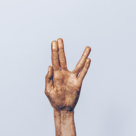 Female hand gesturing against a gray background close-upの写真素材