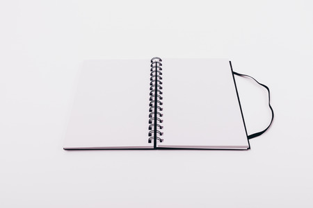 Mock-up open notepad with spring with two blank sheets on white table, close-up.の写真素材