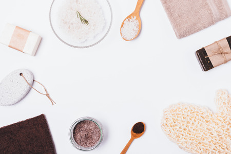 Flat lay frame of items and cosmetic products for bath on white background with empty space in center.の写真素材