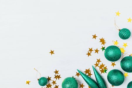 Flat lay Christmas tree decorations and star shaped confetti on white background with copy space.の写真素材