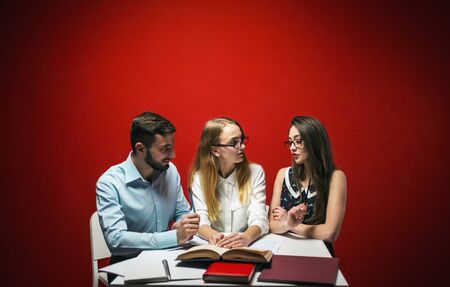 A group of young attractive students have a friendly discussion, teamwork student conceptの写真素材
