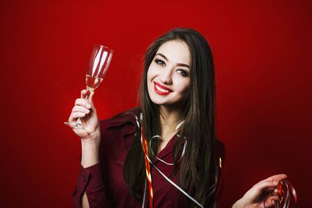 a new year party brunette girl having fun with bocal of champaignの写真素材