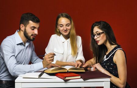 A group of young attractive students have a friendly discussion, teamwork student conceptの写真素材