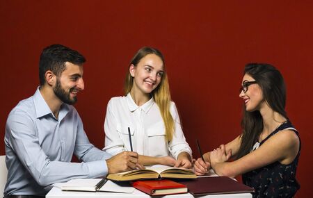 A group of young attractive students have a friendly discussion, teamwork student conceptの写真素材