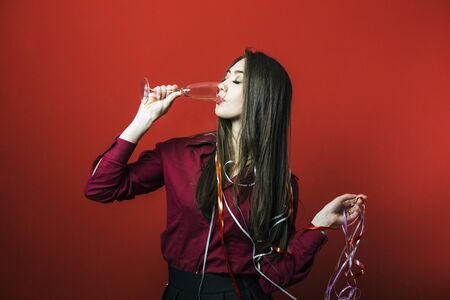 a new year party brunette girl having fun with bocal of champaignの写真素材