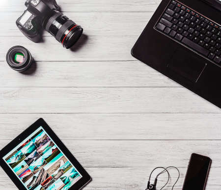 Photography designers workplace, devices on white table top, studio editing conceptの写真素材