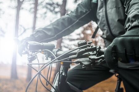 Equiped biker holds bike helm, sport ride conceptの写真素材