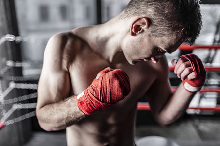 Close up of boxer man with red bandages in the ringの写真素材