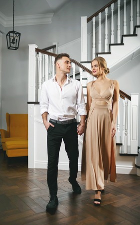 Blonde young couple going around the house