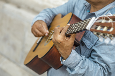 Croped view of street musician who plays on the guitar at the Budapest