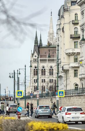 BUDAPEST, HUNGARY - 24 August, 2018: Spring view on the Hungarian Parliament Building of the urban street with cars and peopleのeditorial素材