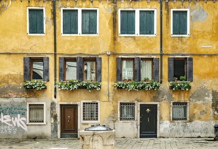 VENICE, ITALY - 25 August, 2018: Typical venetian street view on the building with yellow plasterのeditorial素材