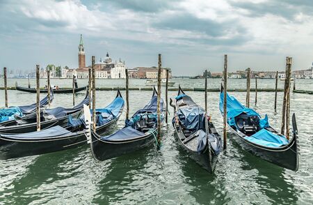 Gondolas in lagoon on the summer sky background, Venice, Italyの写真素材