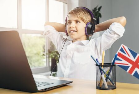 Smart smiling kid enjoys his success in studying English