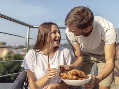 Young man has prepared a surprise breakfast for his girlfriendの写真素材